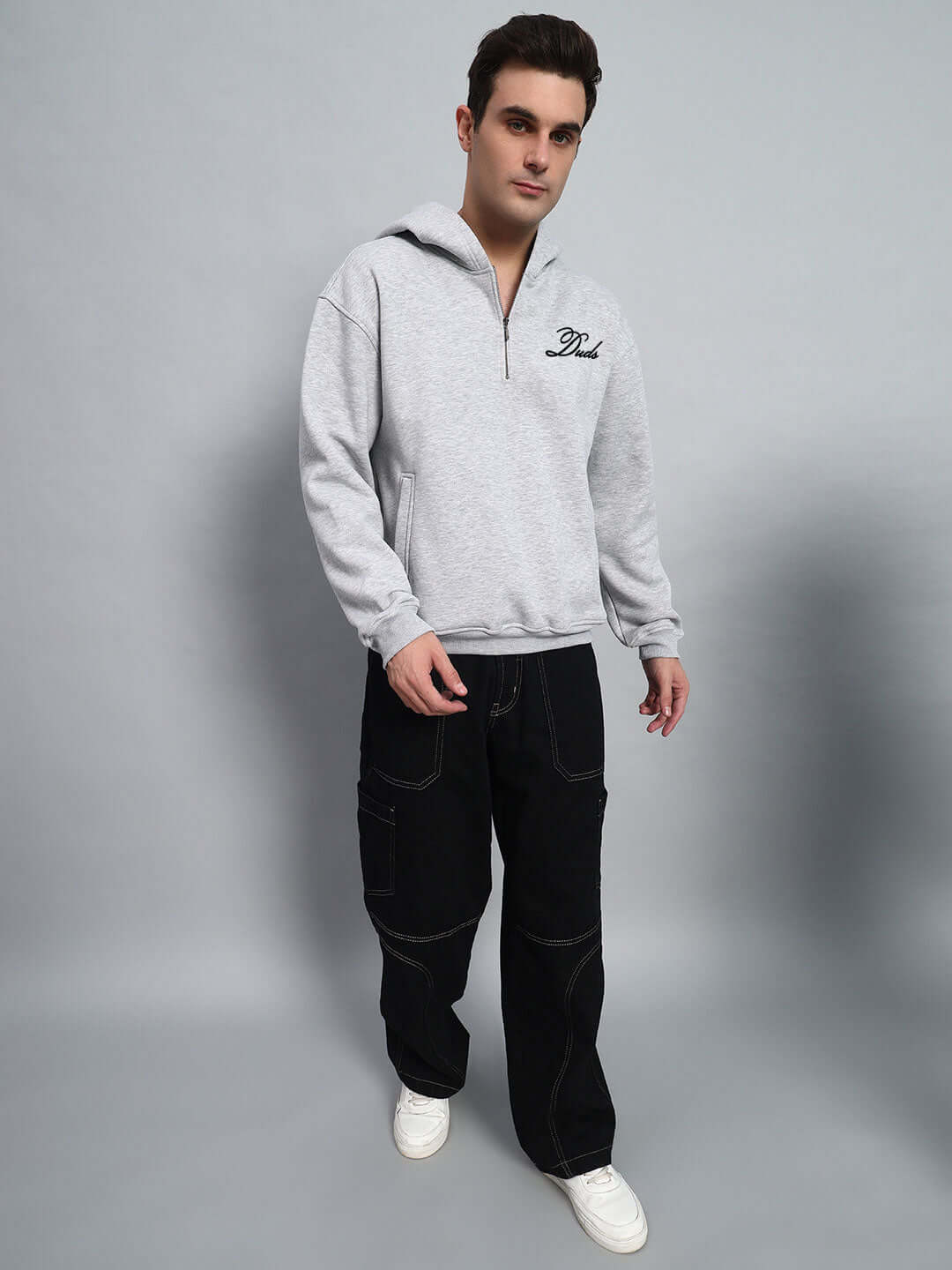 Model wearing AMARILLO FLEECE HOODIE MELANGE GREY with casual pants, showcasing winter fashion.