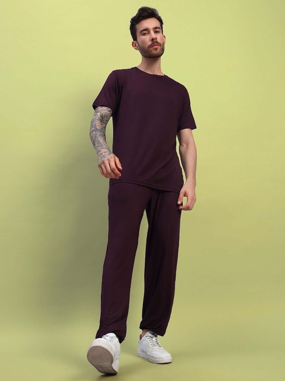 Model wearing AMBLE CO-ORD SET in maroon, made of premium heavy modal fabric, suitable for casual wear, photographed against a green background.