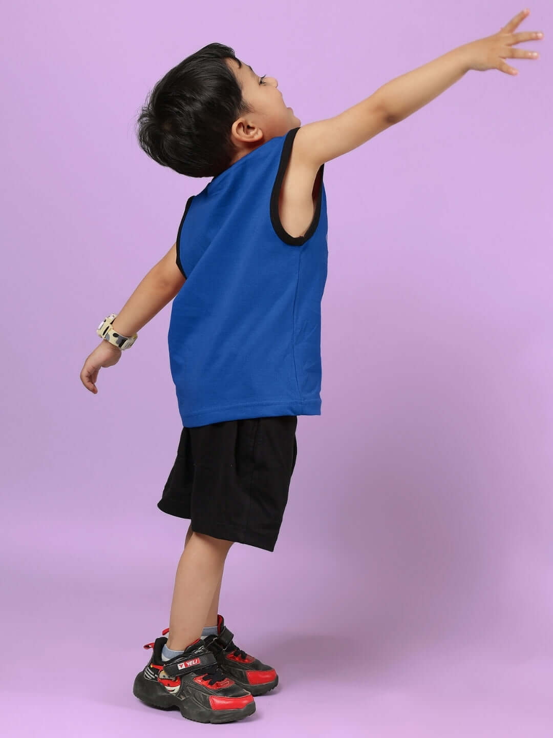 Child wearing AMIGA CO-ORD FOR BOYS & GIRLS BLUE BLACK, stylish blue top and black shorts, perfect blend of sporty and casual fashion.