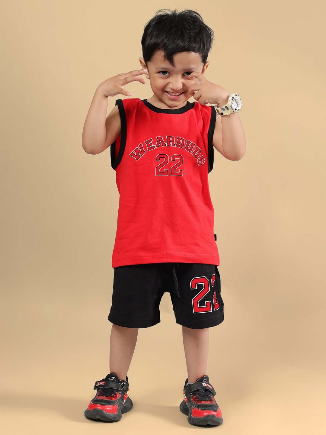Child wearing AMIGA CO-ORD FOR BOYS & GIRLS RED BLACK outfit, showcasing red top and black shorts. Unique design for kids made by DUDS.