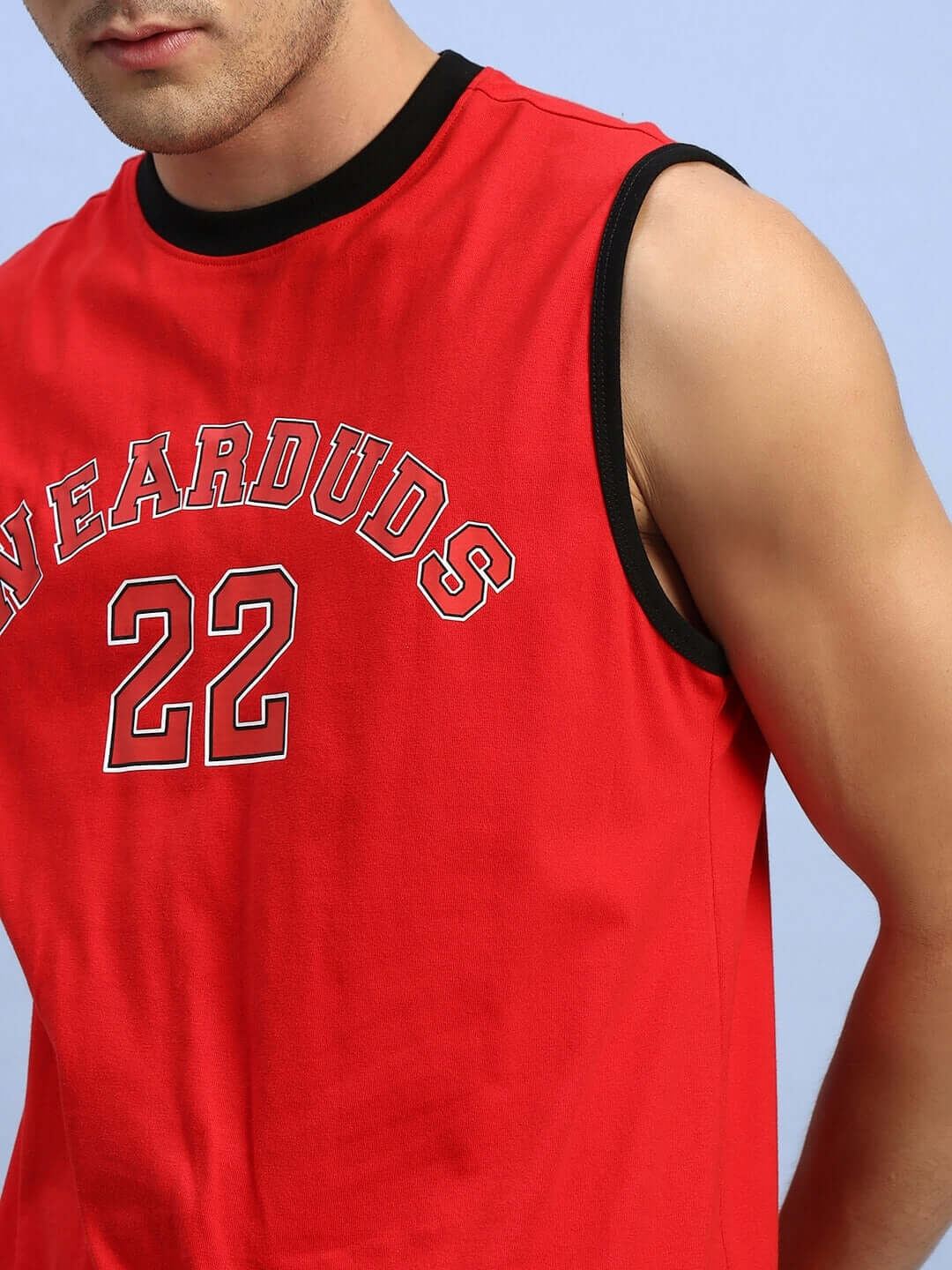 Man wearing red AMIGA GYM T-shirt with 'Swearduds 22' print, showcasing bold athletic style.
