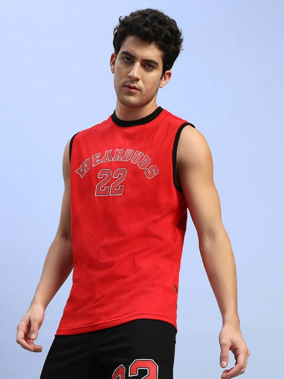 Man wearing red Amiga gym t-shirt with black trim, showcasing sporty design.