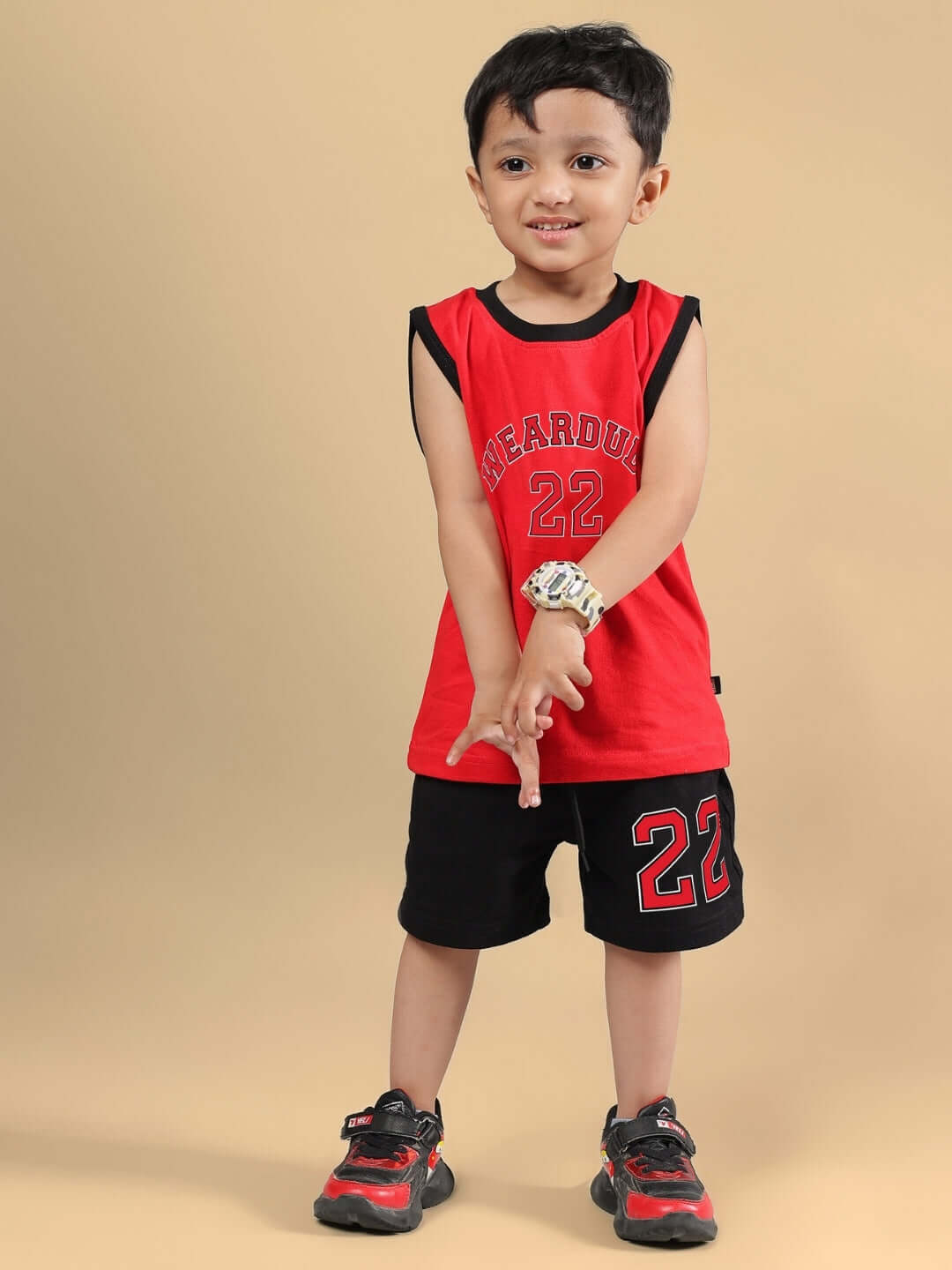 Child wearing AMIGA CO-ORD FOR BOYS & GIRLS RED BLACK, featuring red top and black shorts with number 22 design, perfect for sporty style.