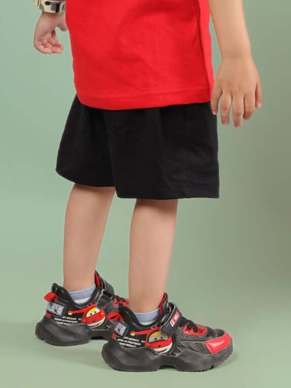 AMIGA SHORTS FOR BOYS & GIRLS BLACK RED featuring a child wearing customized shorts made-to-order by DUDS.