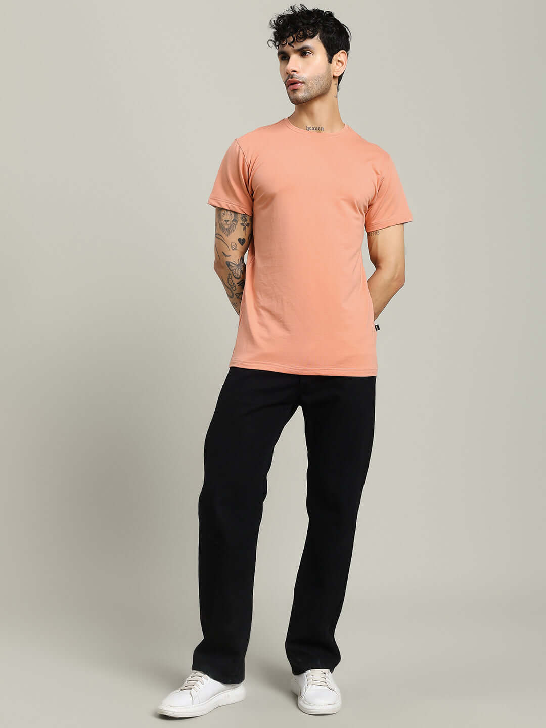 Male model wearing Andrew Regular Fit Peach T-Shirt, made of 100% Cotton, showcasing casual style. Country of Origin: India. Premium fabric.