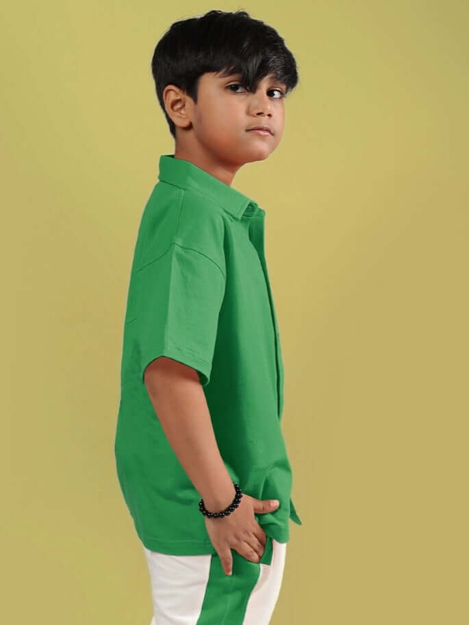 Boy wearing green Angry Sponge shirt by DUDS, showcasing made-to-order clothing for boys and girls with custom fit option.