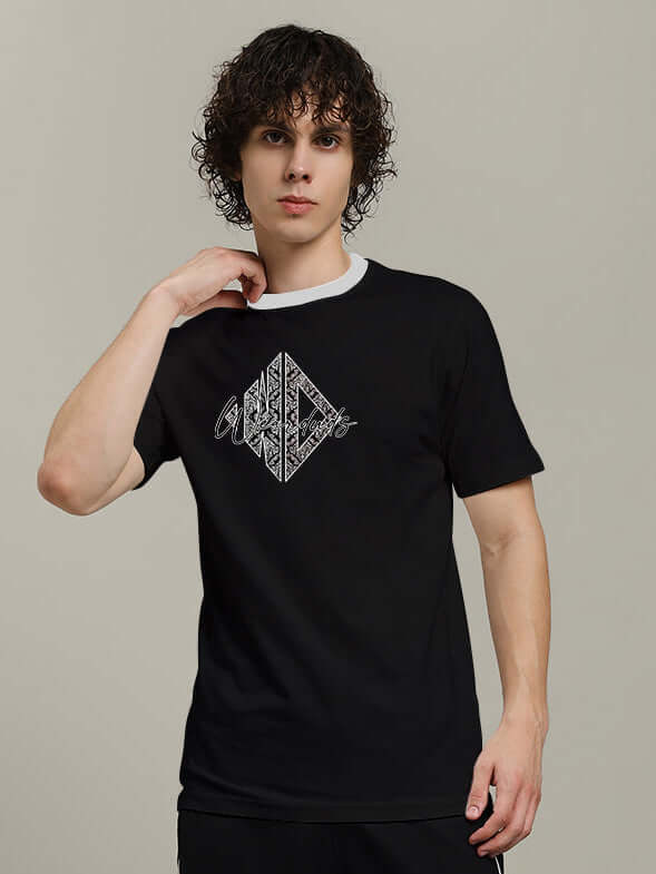 Model wearing Angular Regular Fit Black T-Shirt, made of premium 100% cotton, showcasing trendy design with comfortable fit.