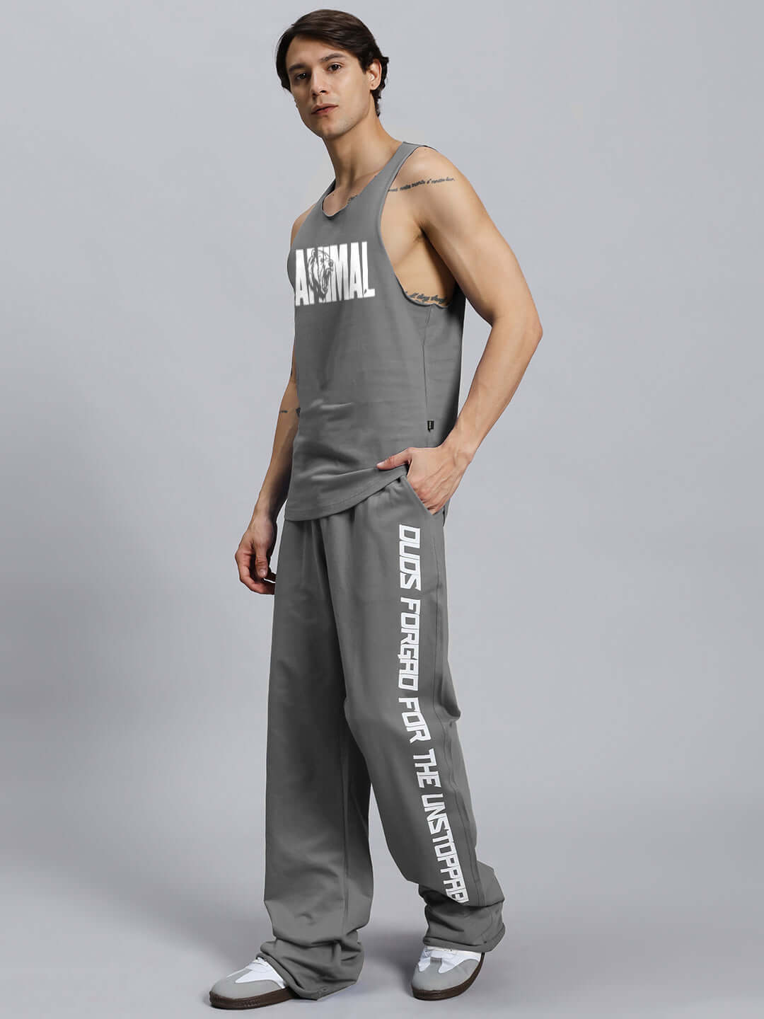 Model wearing grey animal print relaxed fit co-ord set with unisex joggers and tank top, made from bio-washed cotton.