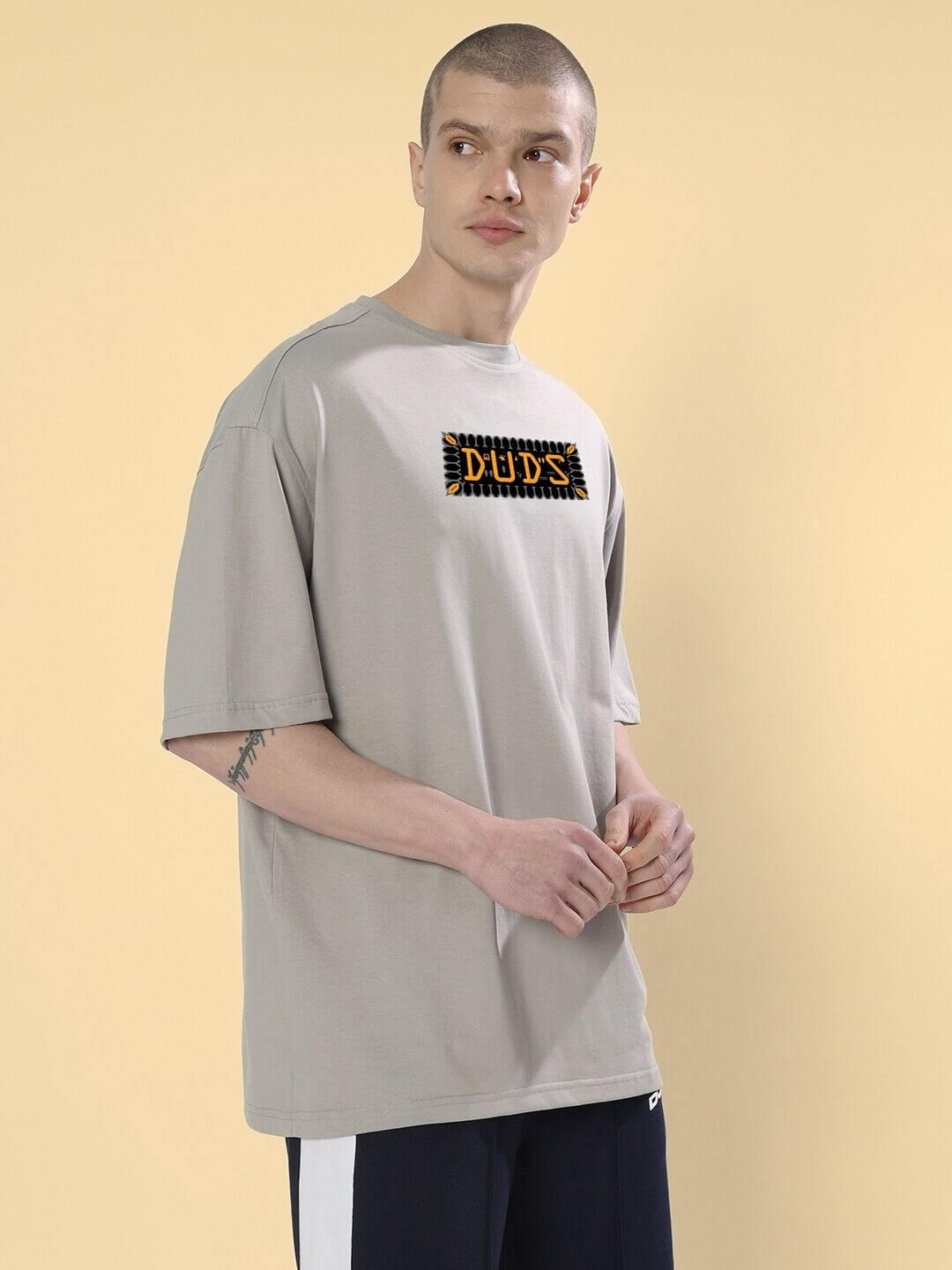 Model wearing ANUBIS EGYPTIAN PRINTED OVERSIZED T-SHIRT GREY with Anubis artwork, perfect for culturally rich fashion statements.
