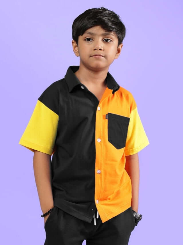 Young boy wearing APEX multi-colored black shirt, designed for boys and girls. Made-to-order by DUDS, customizable for perfect fit.