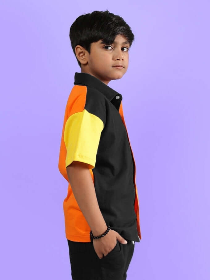 APEX SHIRT FOR BOYS & GIRLS MULTI BLACK worn by child model, side view, showcasing colorful design on purple background.