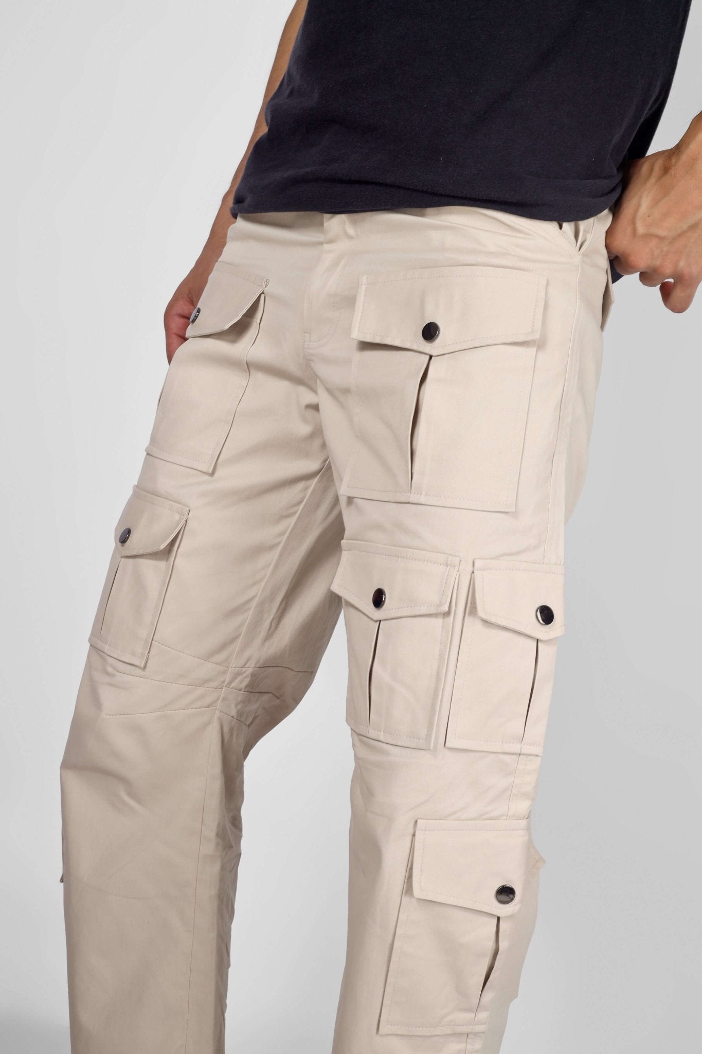Close-up of ARCADIA WHITE 14 POCKET CARGO PANTS showcasing multiple pockets for fashion and functionality.