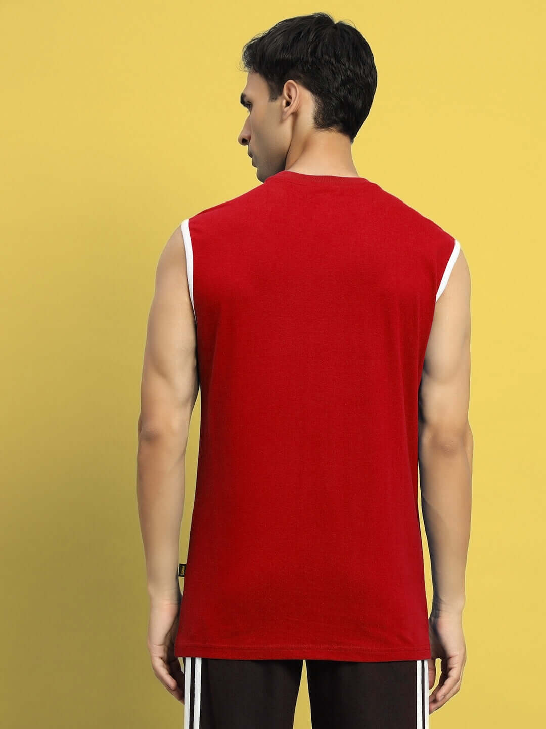 Man wearing ASTRA red gym t-shirt, showcasing back view, available with custom fit option for personalized sizing.