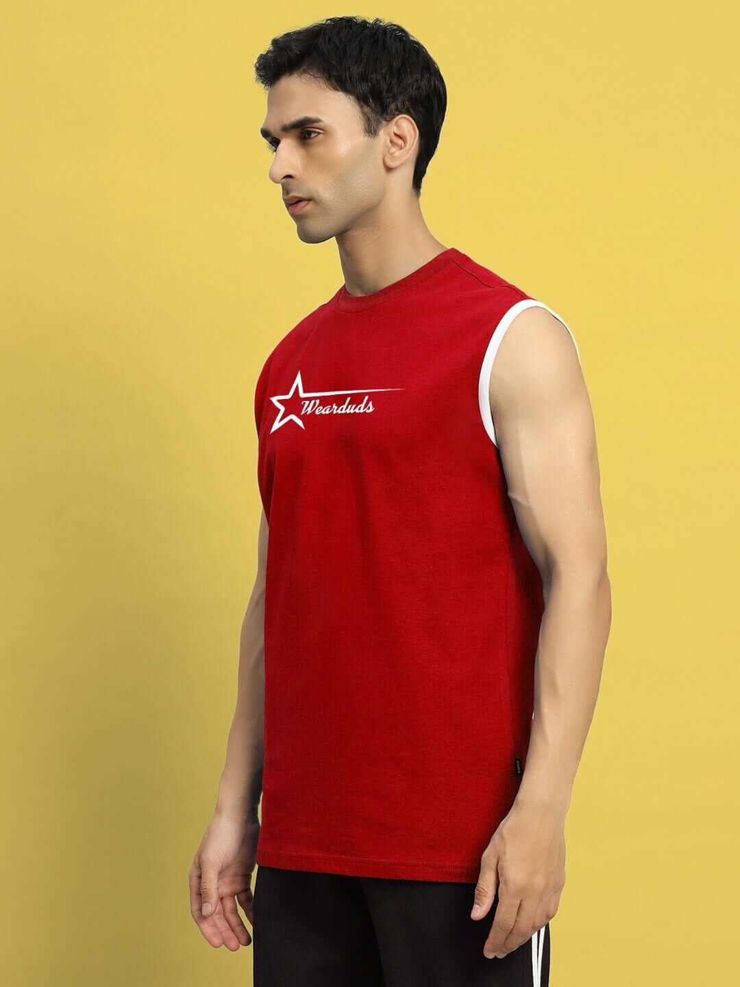 Model wearing a red ASTRA gym t-shirt, showcasing the sleeveless design and casual fit, ideal for workouts.