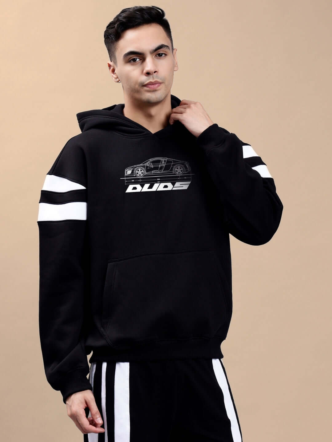 Model wearing AUDI R8 FLEECE COLORBLOCK OVERSIZE HOODIE BLACK featuring sporty design and relaxed fit.