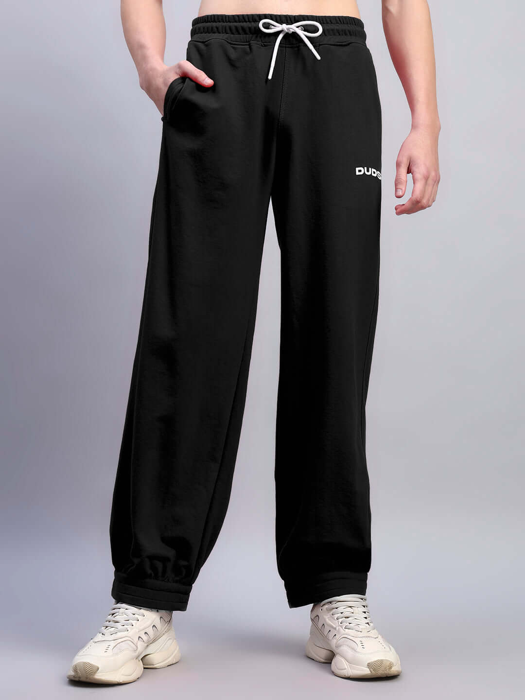 Model wearing Austrian relaxed-fit black joggers, showcasing the comfortable design by DUDS, perfect for casual wear.