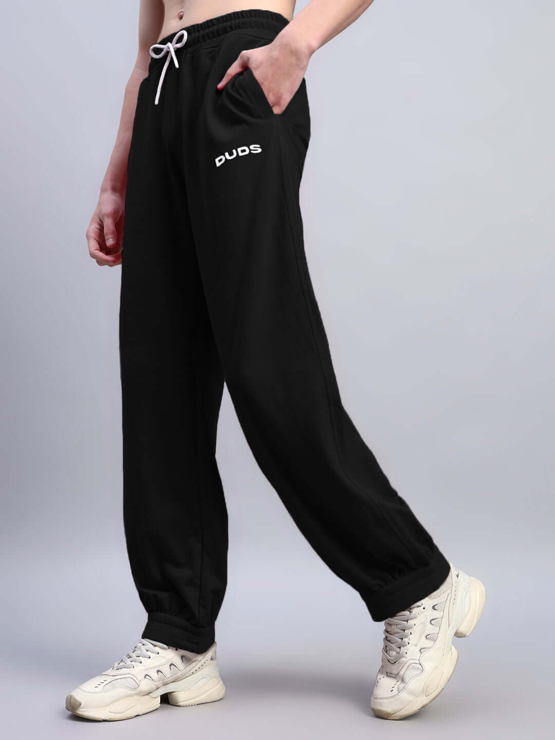 Model wearing black Austrian relaxed-fit joggers by DUDS, featuring a comfortable design, ideal for customized fit. Made to order.