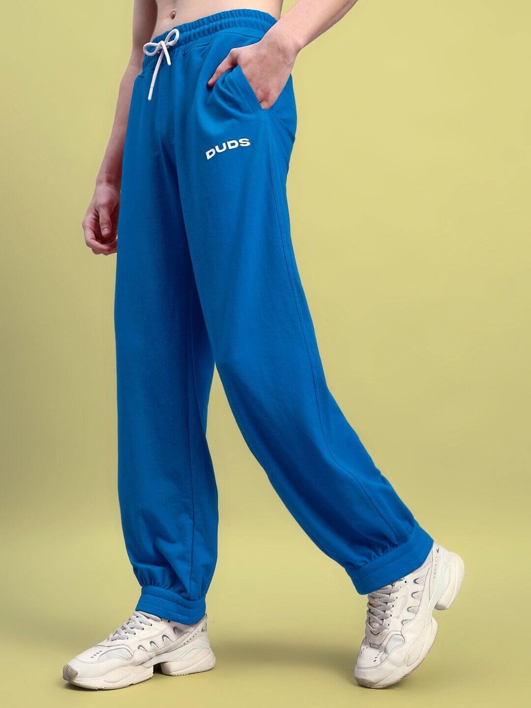 AUSTRIAN relaxed-fit joggers in blue by DUDS, featuring elastic waistband and pockets, ideal for comfort and customization options.