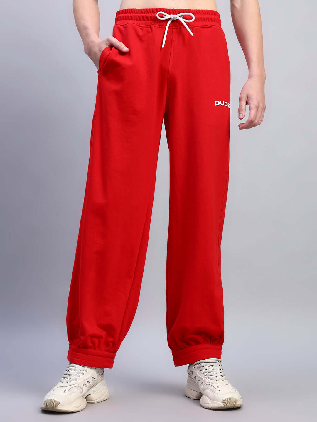 Model wearing Austrian relaxed-fit red joggers with drawstring waist from DUDS.