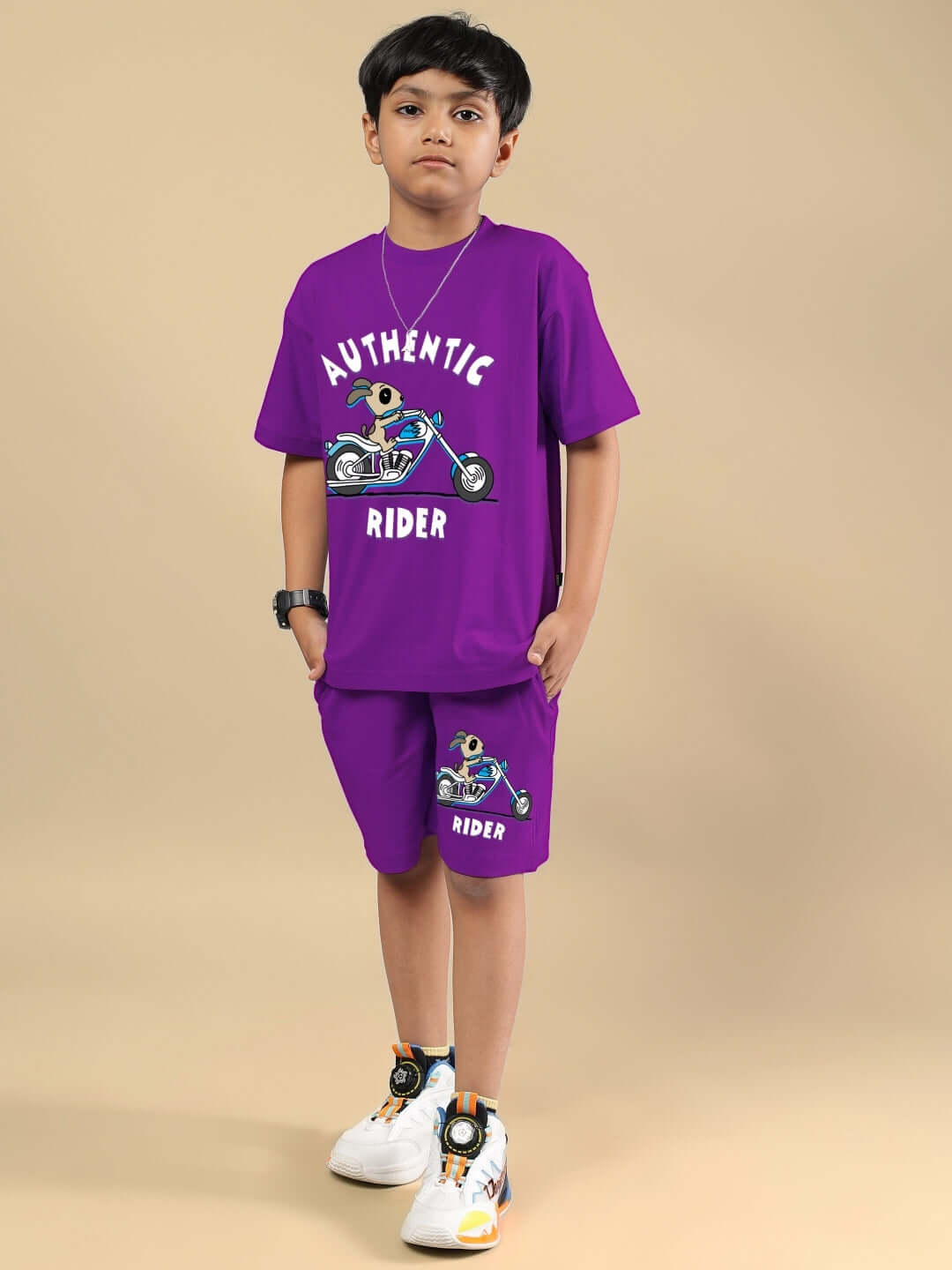 Child wearing purple Authentic Rider co-ord set for boys and girls, featuring a motorcycle graphic. Made-to-order by DUDS.