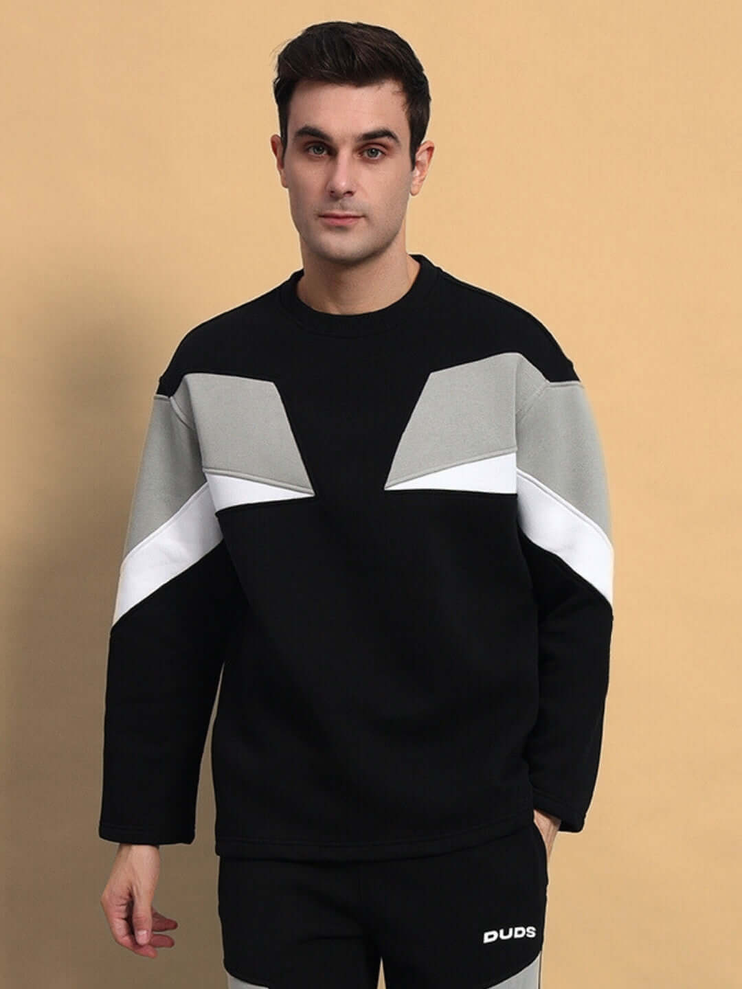 Man wearing black aviator fleece sweatshirt with geometric design.