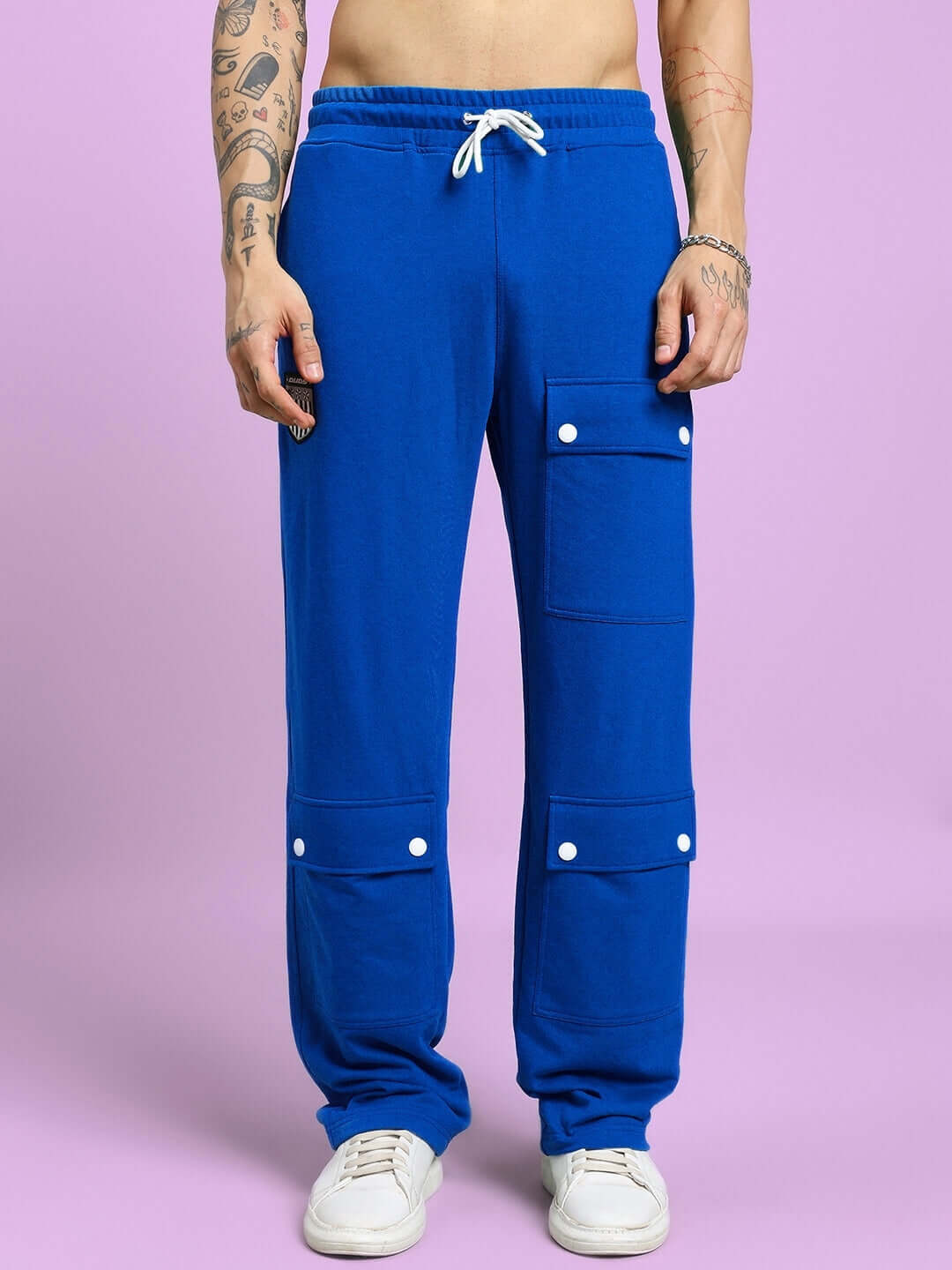Person wearing blue Awesome Flap Pocket Baggy Jogger with customized fit standing against a purple background.