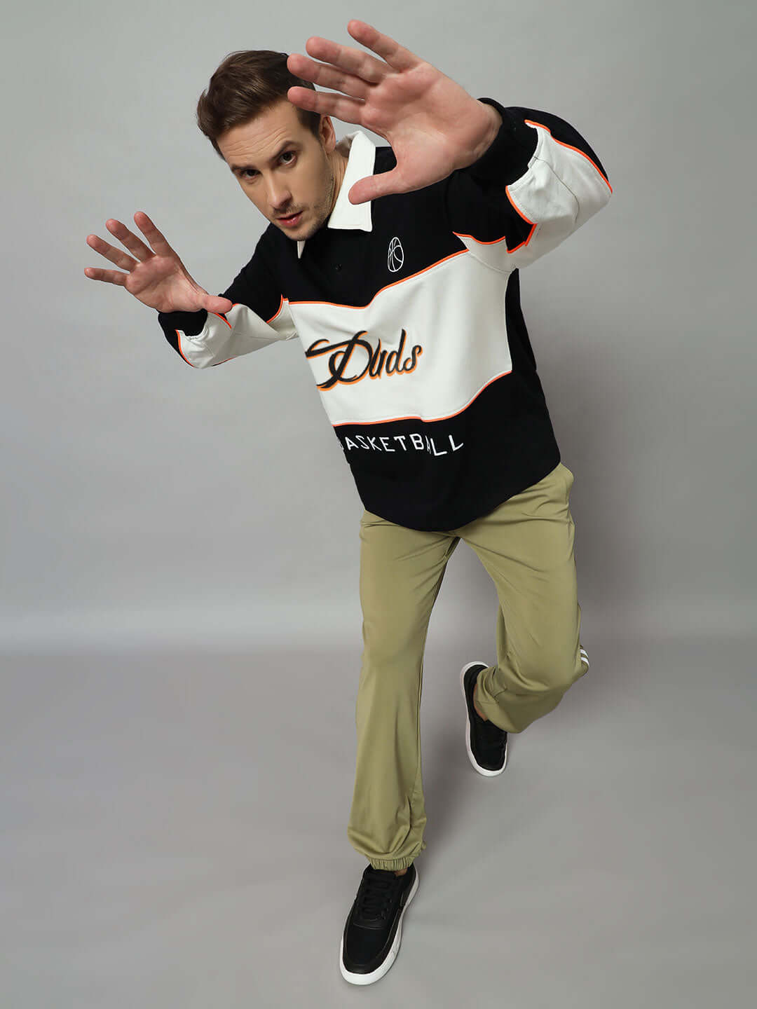 Model wearing B-Ball Oversized Sweatshirt in Black-Off White with bold basketball design.