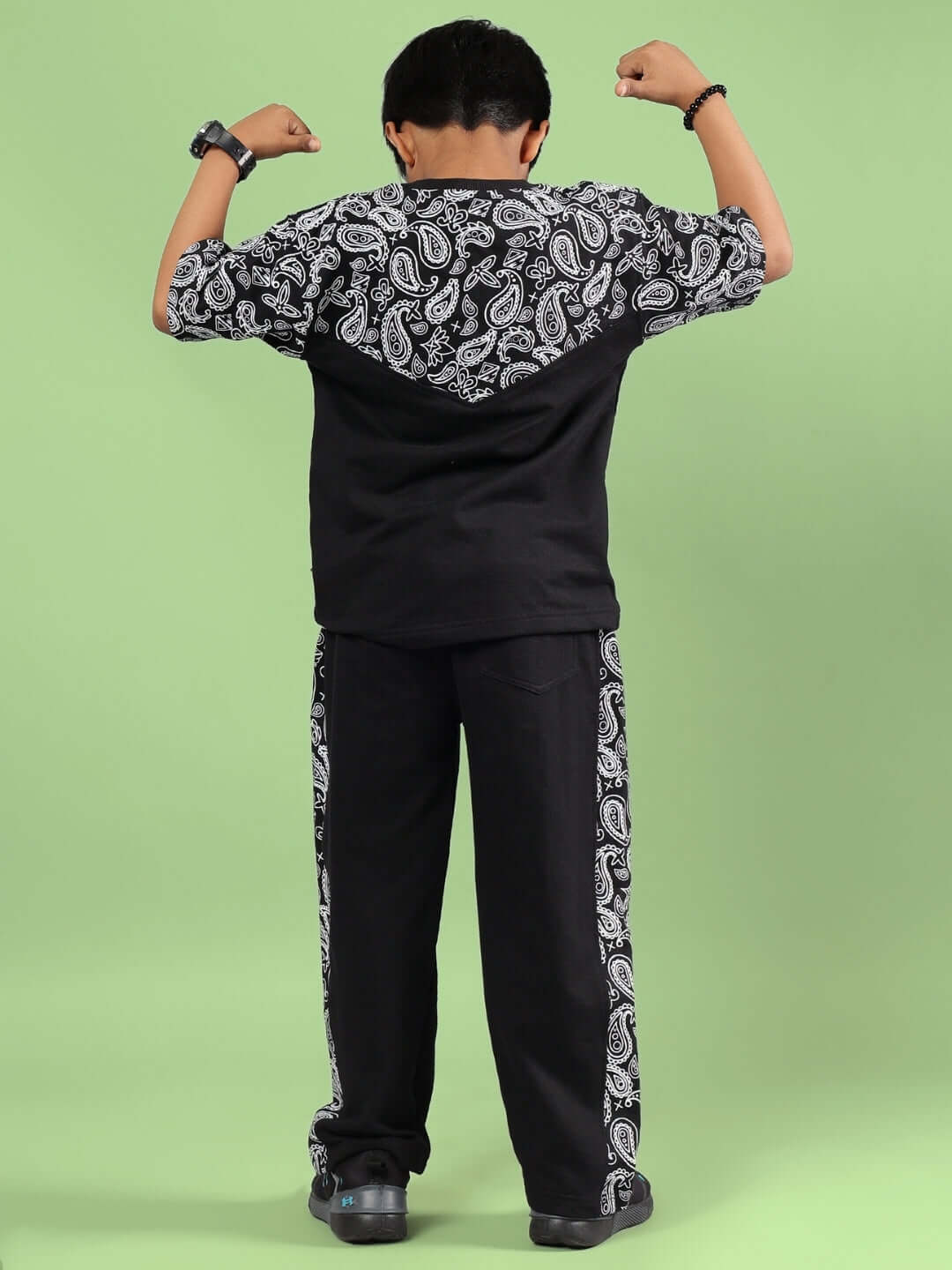 Child wearing the BALADEER CO-ORD FOR BOYS & GIRLS BLACK showing the back design with paisley patterns, perfect for trendy and active kids.