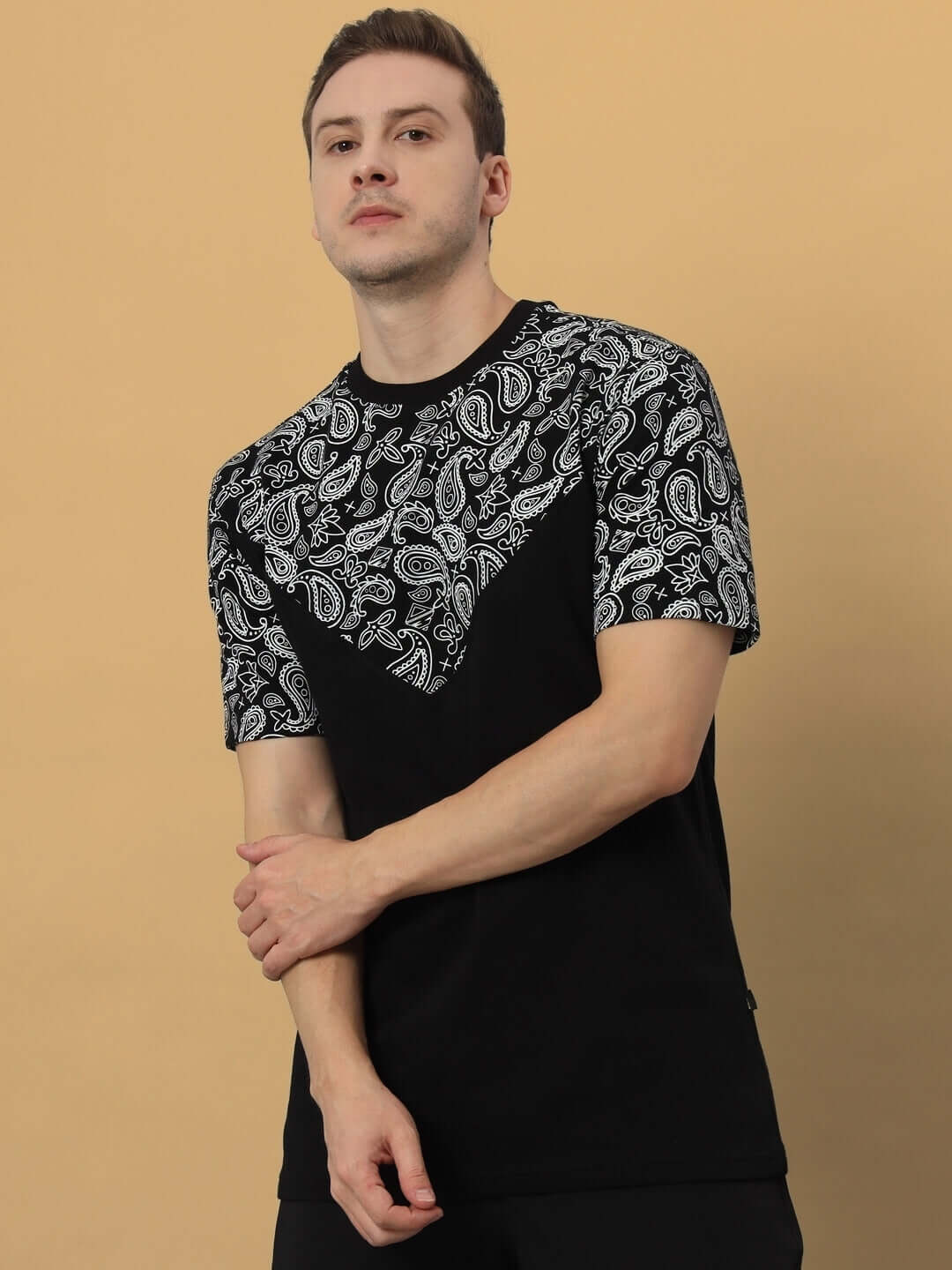 Model wearing black Balladeer oversized t-shirt with paisley print, made from premium cotton French Terry, ideal for casual wear.
