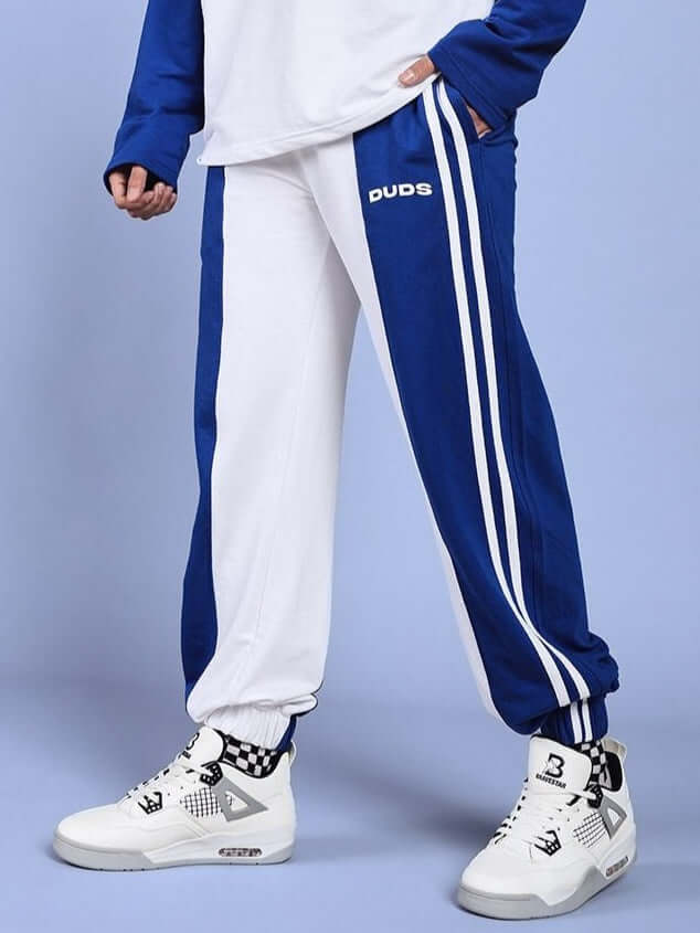 Balmy relaxed fit jogger in white-blue with DUDS branding, shown with sneakers; customizable sizing available.