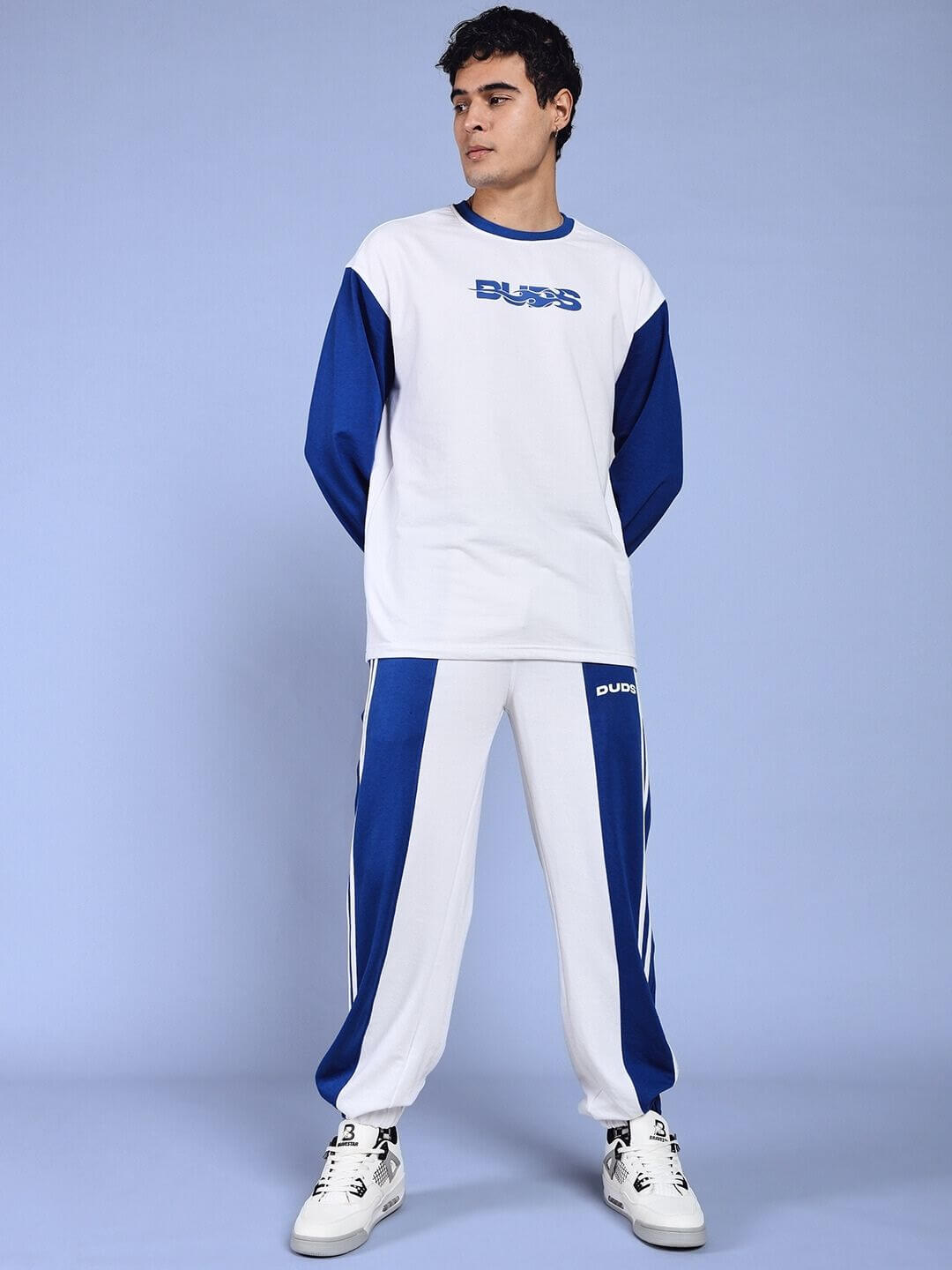 Model wearing Balmy Relaxed Fit Jogger in white-blue by DUDS, showcasing stylish loungewear for men.