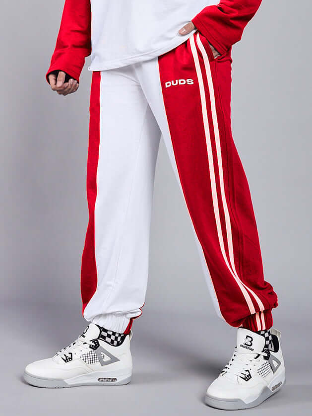 Person wearing Balmy Relaxed Fit Jogger in white and red with stylish shoes, showcasing sporty and comfortable style by DUDS.