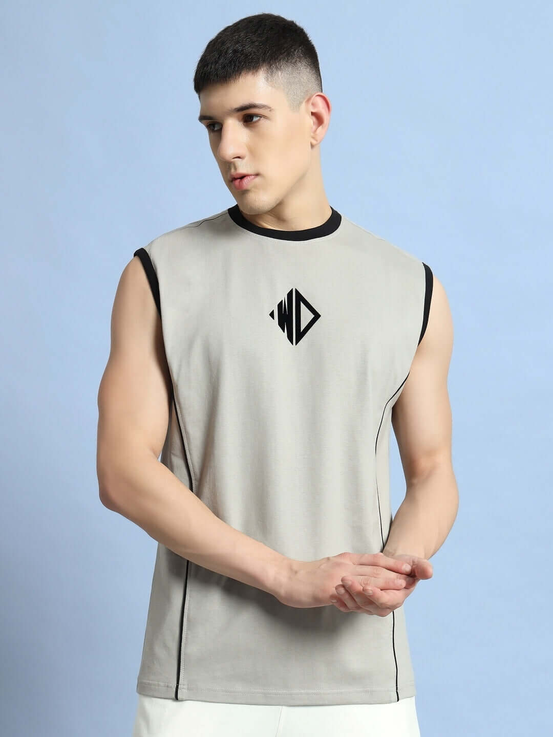 Man wearing BARE ARMS grey gym t-shirt with logo, showcasing sleeveless design ideal for workout comfort and style.