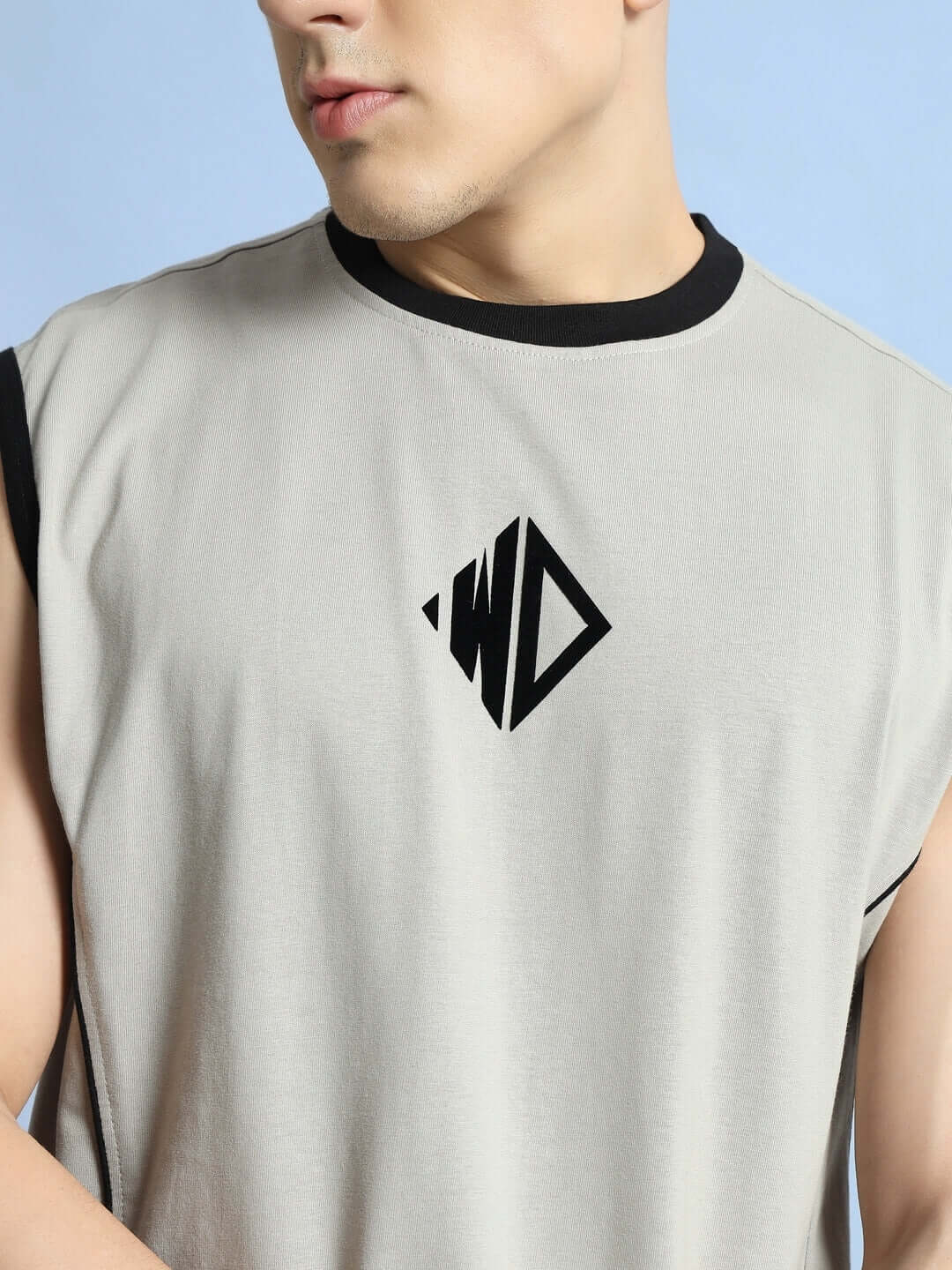 Close-up of a man wearing a grey BARE ARMS gym t-shirt featuring a black logo on the chest, perfect for custom fit options.