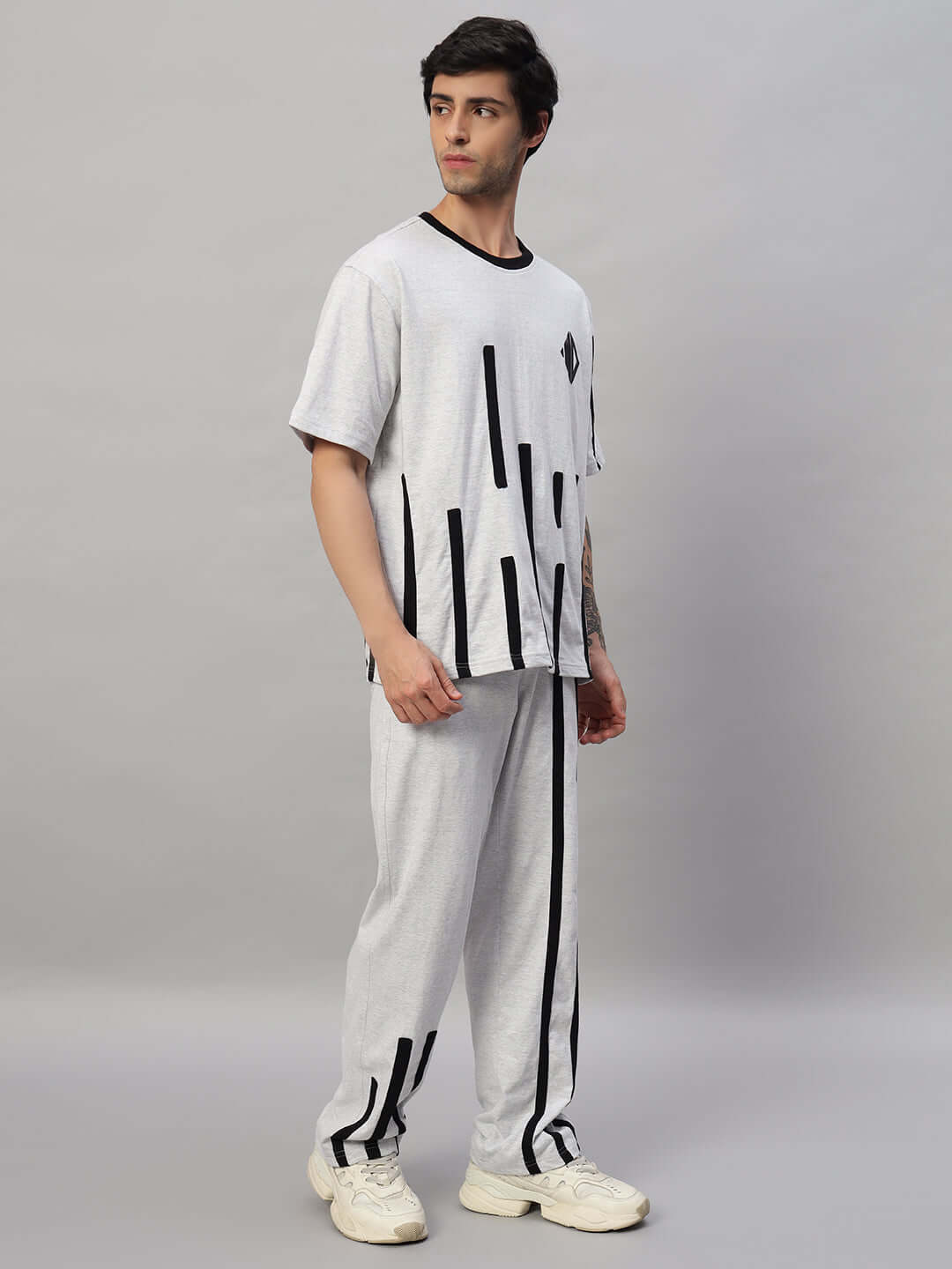 Man wearing the BASTILLE OVERSIZED CO-ORD SET MELANGE GREY, featuring relaxed tailoring and chic design for everyday functionality.