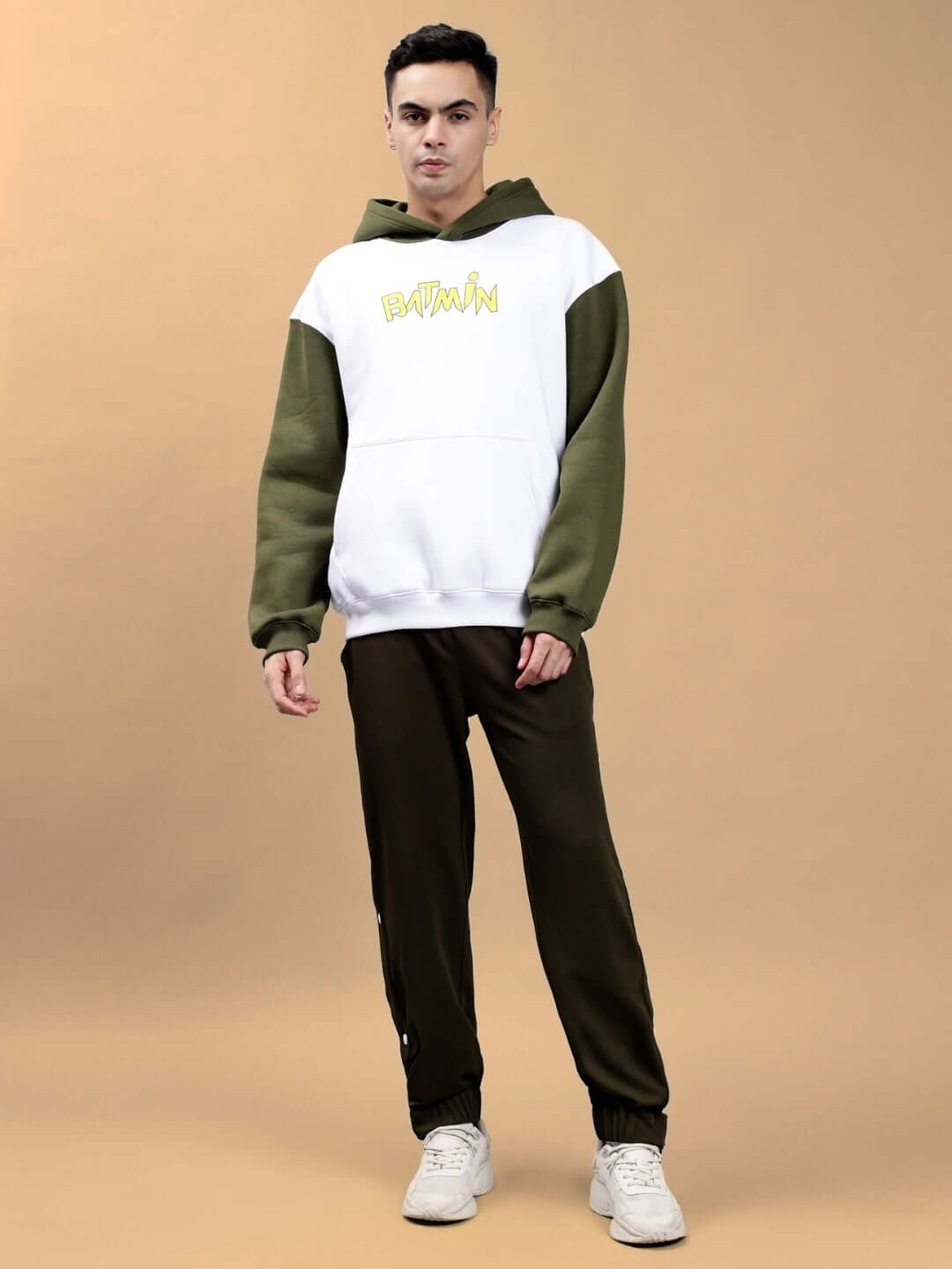 Male model wearing BATMIN COLORBLOCK OVERSIZED FLEECE HOODIE WHITE-OLIVE GREEN with logo, showcasing streetwear style.