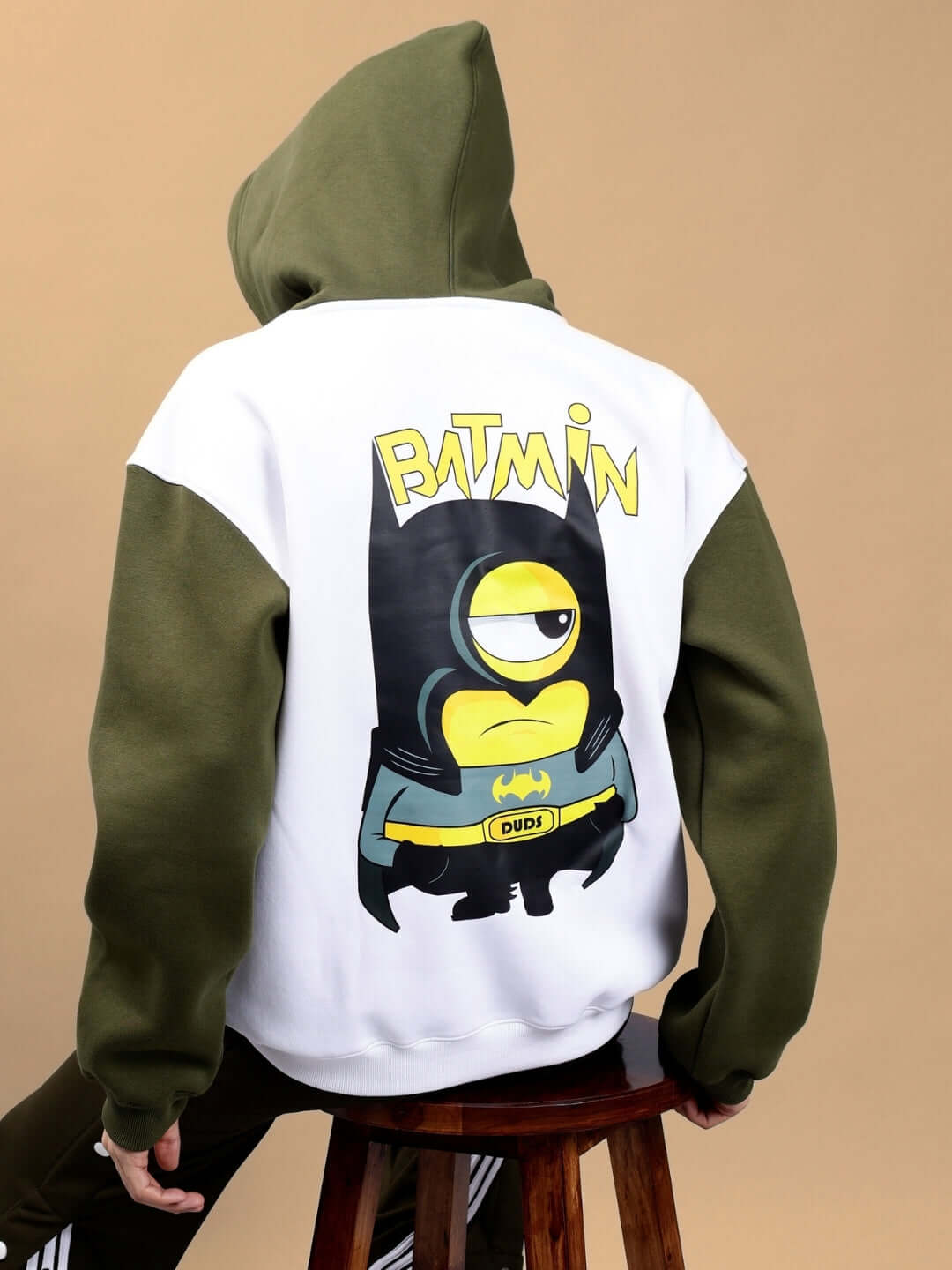 Person wearing BATMIN COLORBLOCK OVERSIZED FLEECE HOODIE WHITE-OLIVE GREEN, featuring a bold graphic and colorblock design.