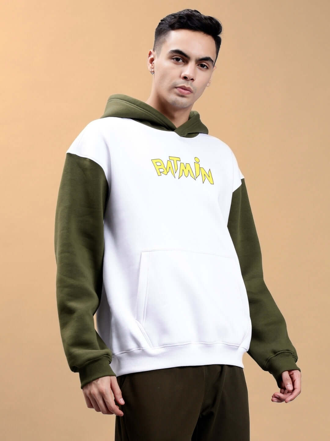 Model wearing BATMIN COLORBLOCK OVERSIZED FLEECE HOODIE WHITE-OLIVE GREEN, showcasing streetwear style with two-tone design.