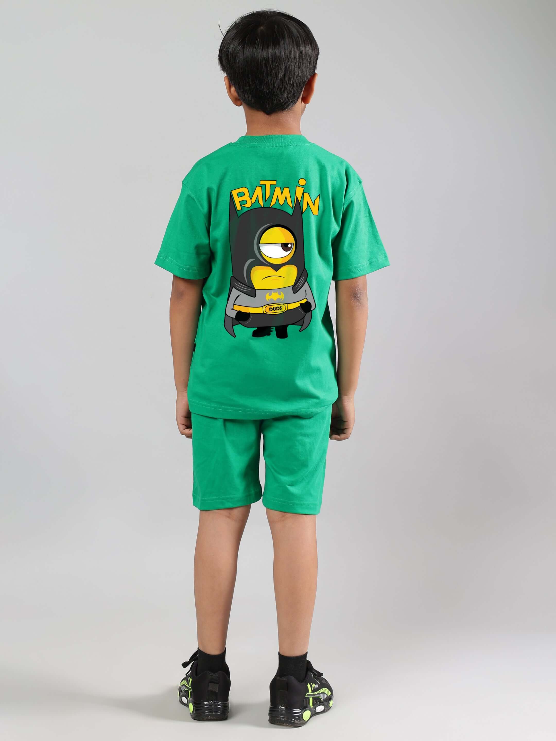 Child wearing a green Batmin co-ord set with cartoon print, suitable for boys and girls. Perfect for custom fit orders from DUDS.
