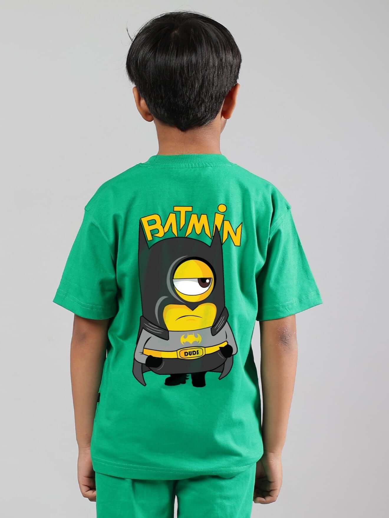 Child wearing green Batmin T-shirt with cartoon print on back; made from 100% cotton, ideal for boys and girls.