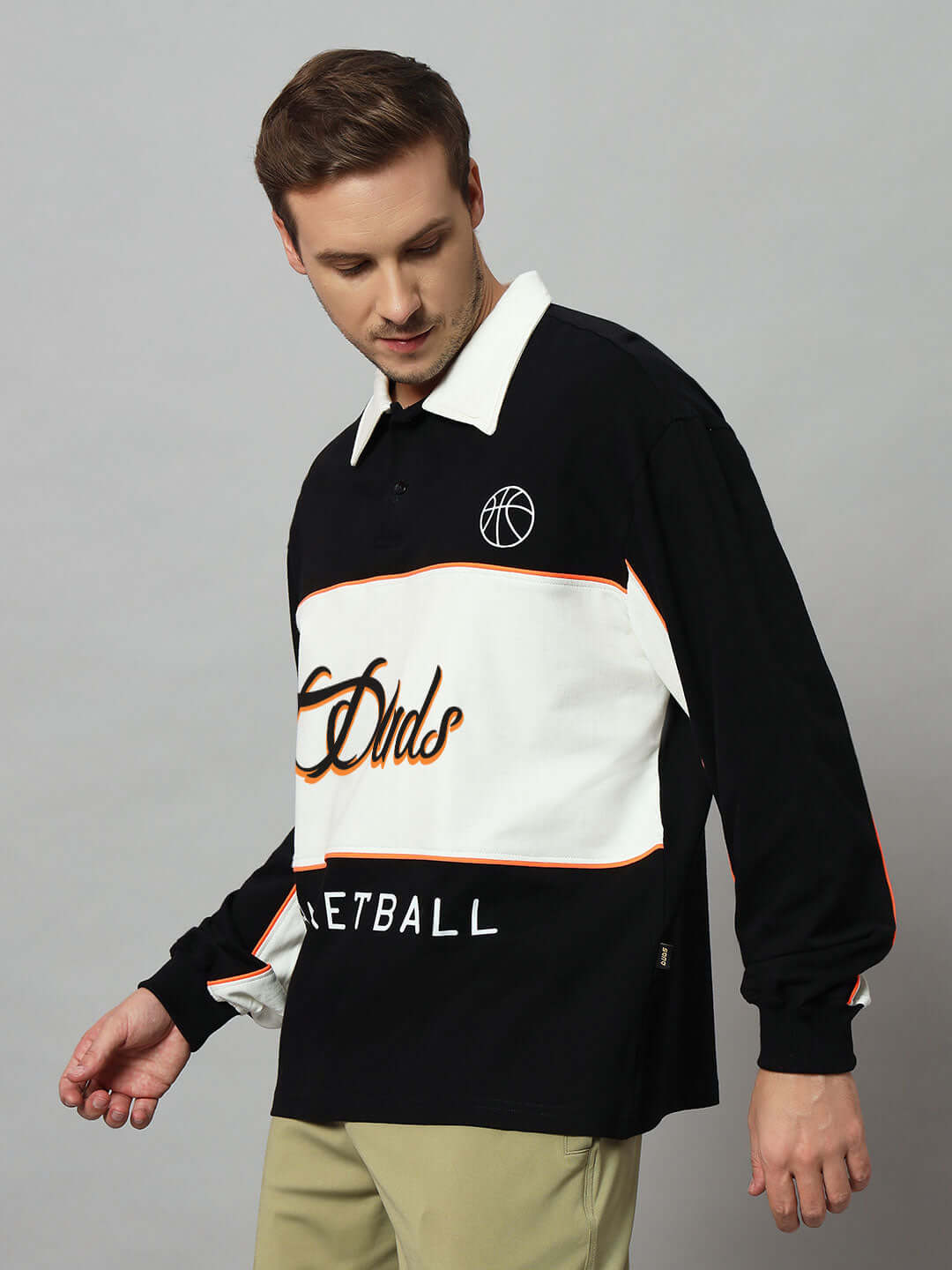 Model wearing B-Ball oversized sweatshirt in black-off white, featuring premium cotton fabric and basketball design.