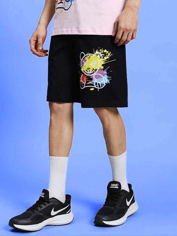 BE KIND REGULAR FIT SHORTS BLACK with colorful design, worn by model, showcasing stylish versatility and comfort.