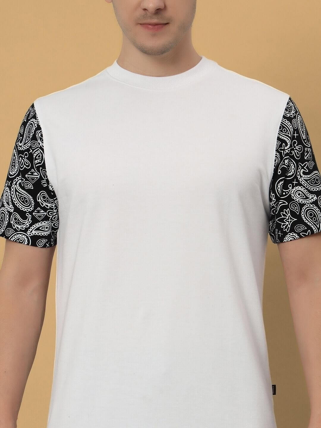 BEASLEY OVER-SIZED T-SHIRT WHITE with patterned sleeves, featuring a comfortable and stylish design, worn by a model against a tan background.