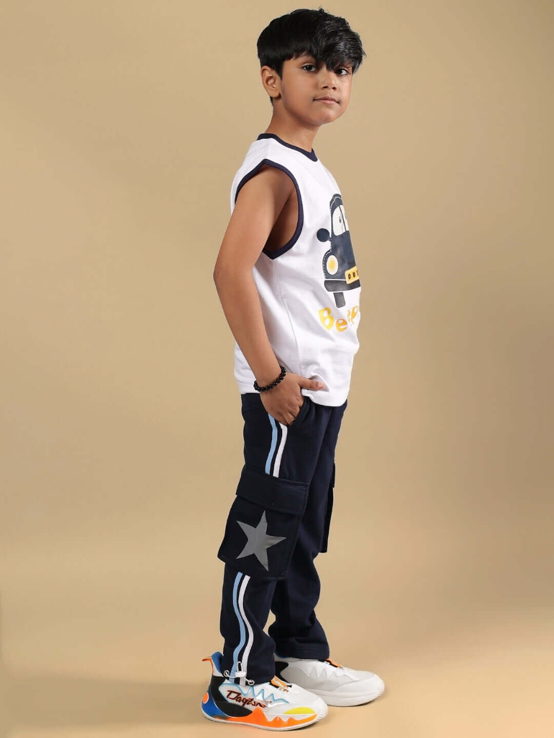 Child wearing BEEP BEEP CO-ORD FOR BOYS & GIRLS WHITE NAVY, featuring a white top and navy pants with playful graphics.