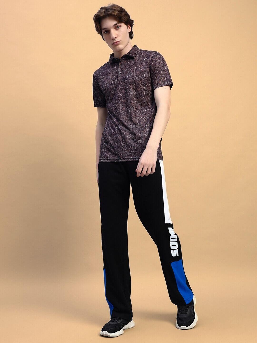 Man wearing BELGIANS RELAXED-FIT JOGGERS BLACK BLUE, showcasing streetwear style with a relaxed silhouette in a black and blue color scheme.