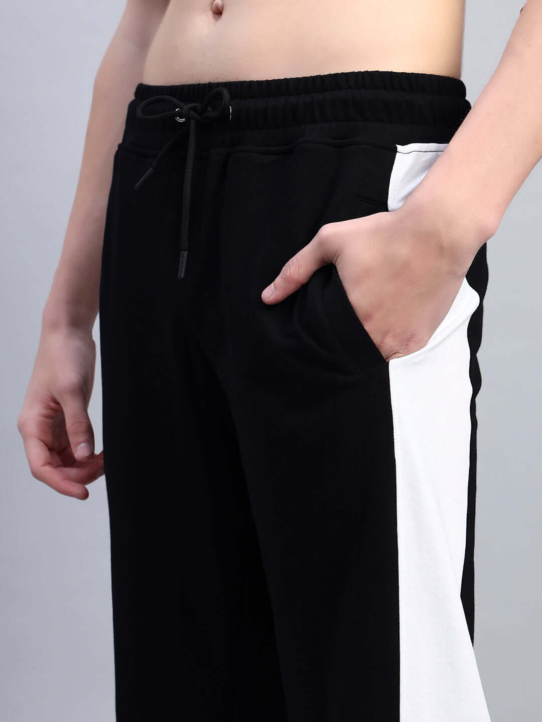 Close-up of black and white relaxed-fit joggers from BELGIANS by DUDS, showcasing comfortable design and pocket details.