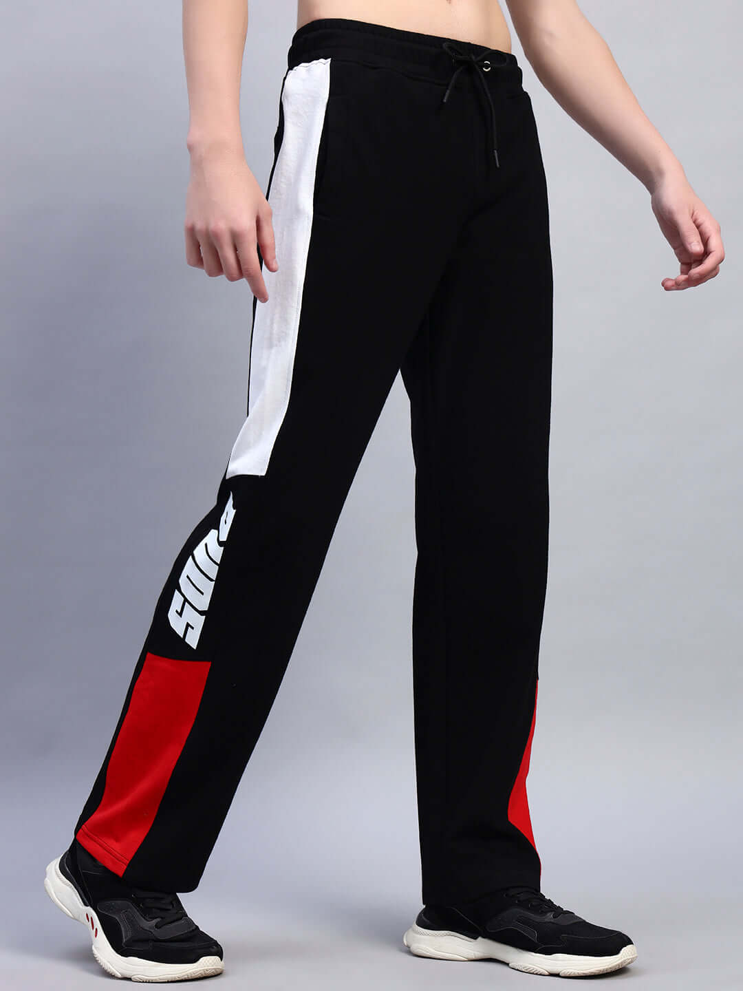 Black red relaxed-fit joggers by DUDS, featuring bold side stripes, ideal for custom fit orders, made by experienced tailors.