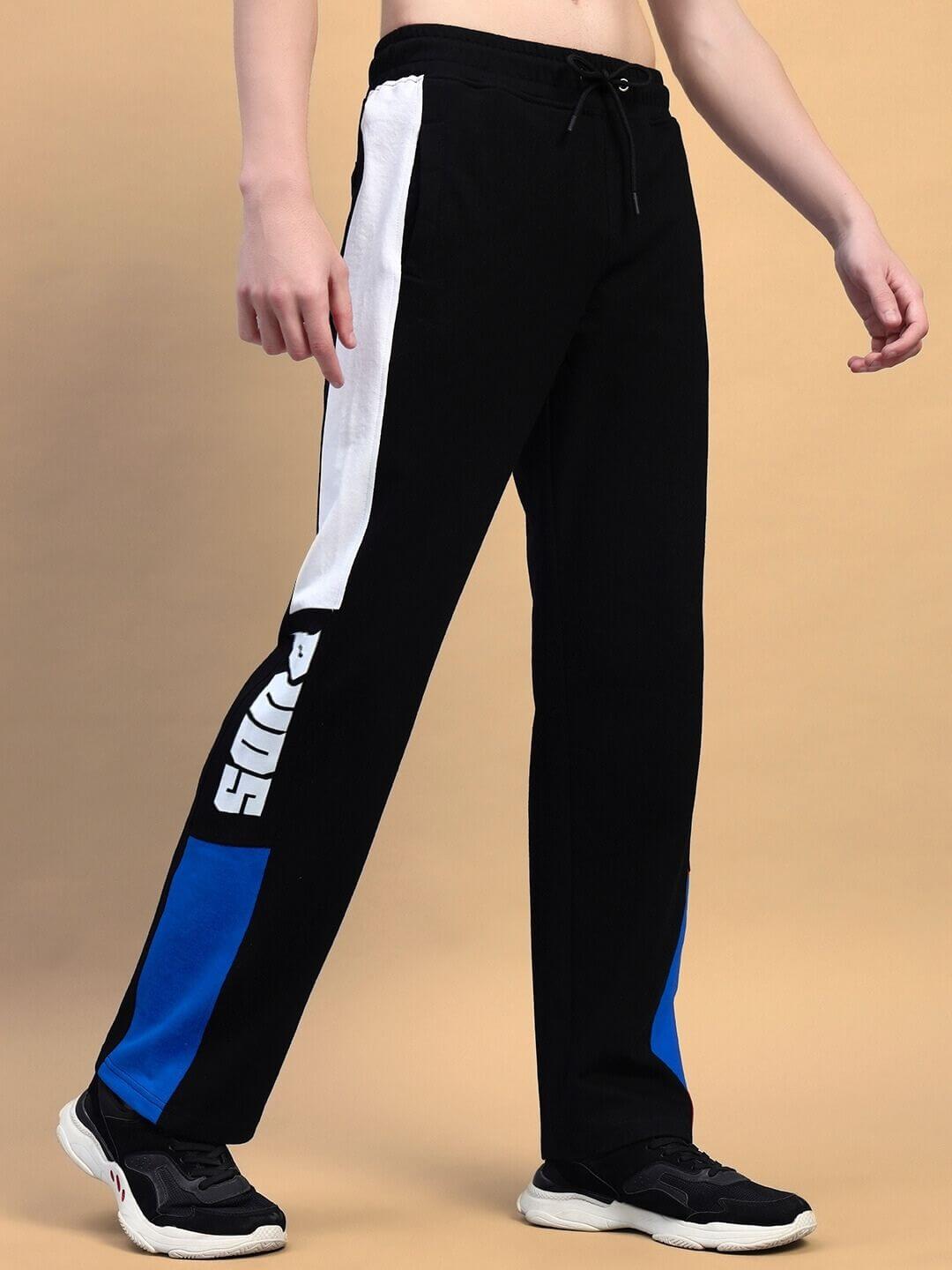 Model wearing black blue relaxed-fit joggers with white side stripes, showcasing comfortable style by DUDS. Tailored, made-to-order product.