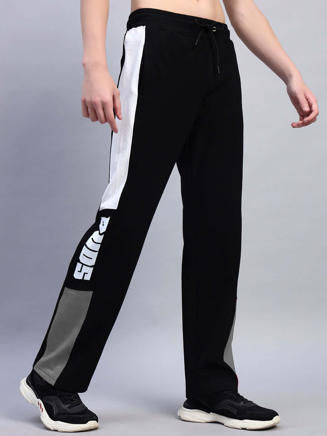 Person wearing Belgians relaxed-fit joggers in black grey by DUDS, featuring comfortable design and custom fit option.