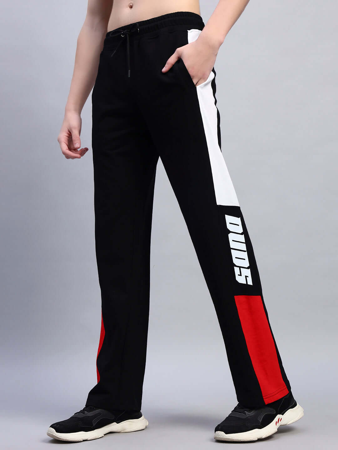 Black and red Belgian relaxed-fit joggers by DUDS with side stripes, shown worn by model.